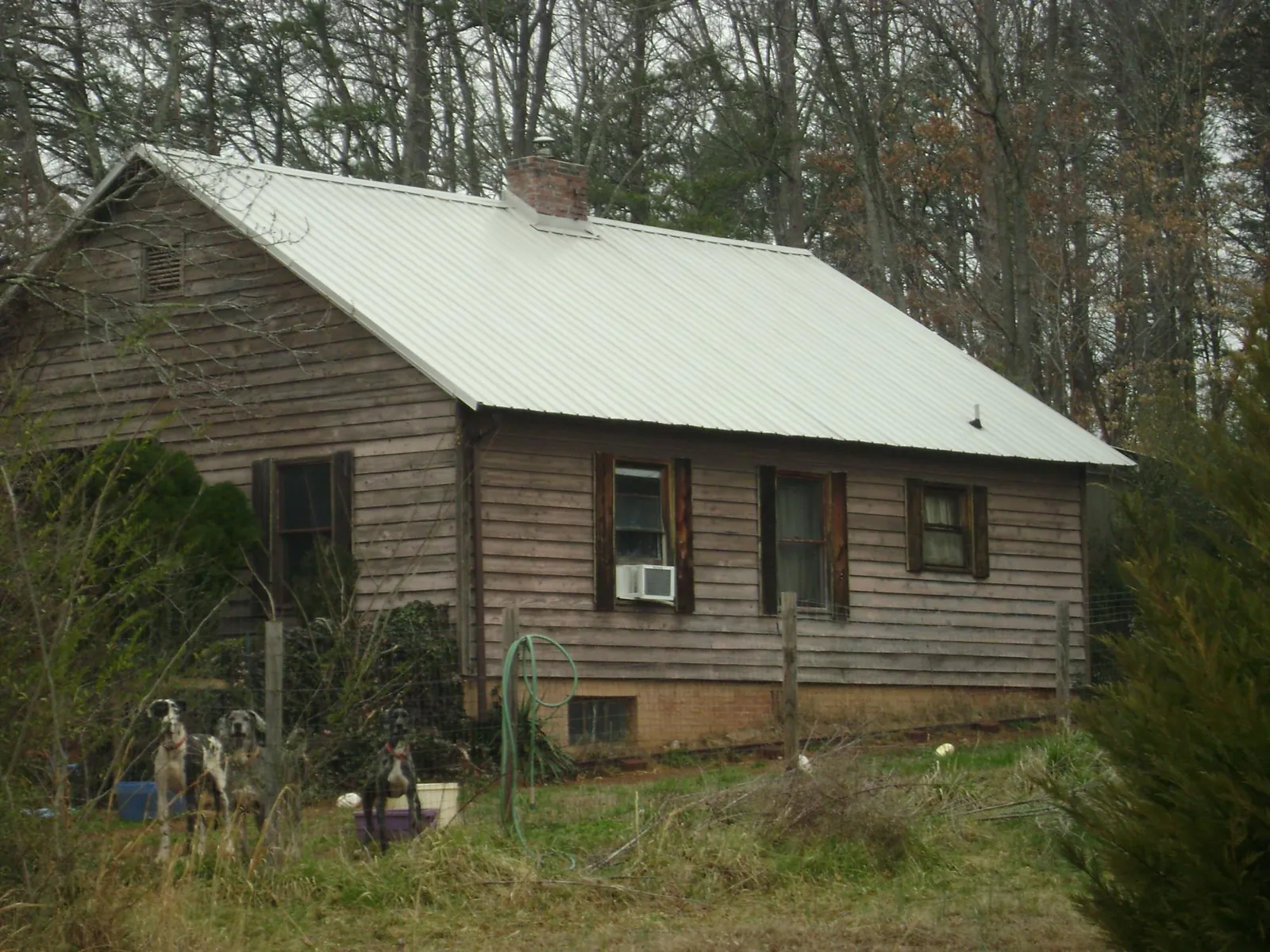 White metal roof on an old wood sided farmhouse, from a Metal Roof Installation job in Mertztown